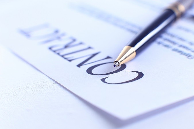 Close-up of pen on contract.