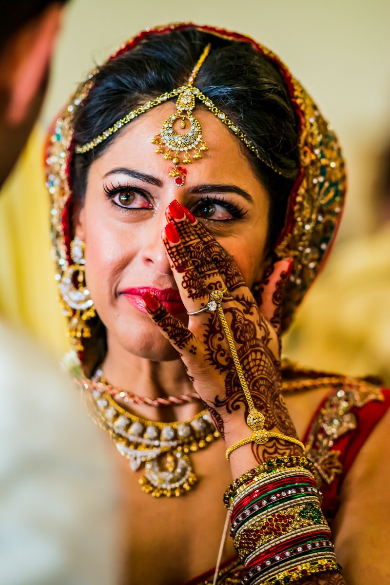 Indian Bride whipping away a tear 