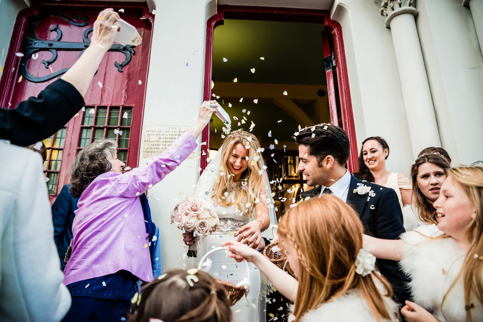 Bride and Groom leaving church with confetti being thrown