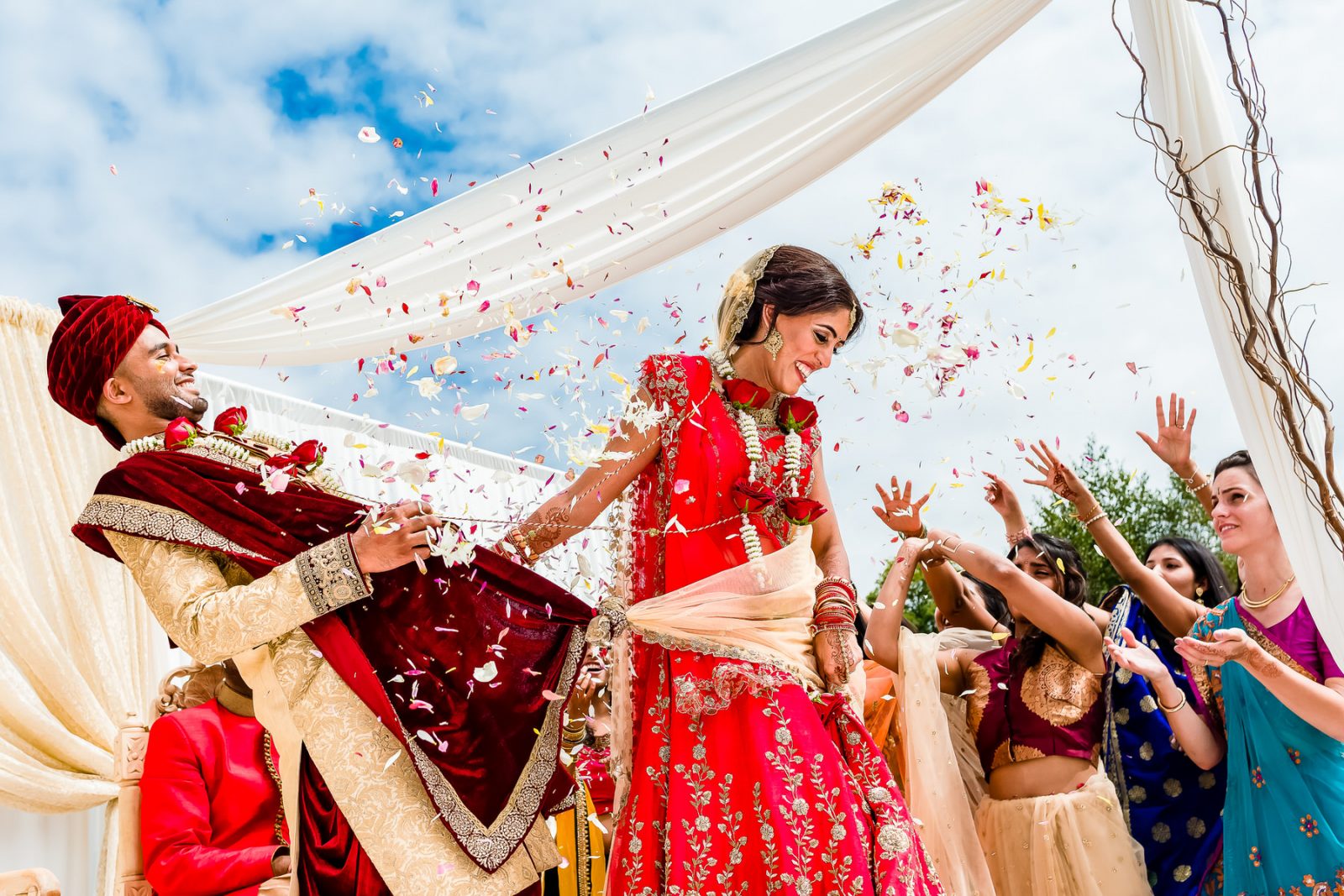 Indian Bride and Groom at wedding with confetti being thrown at them