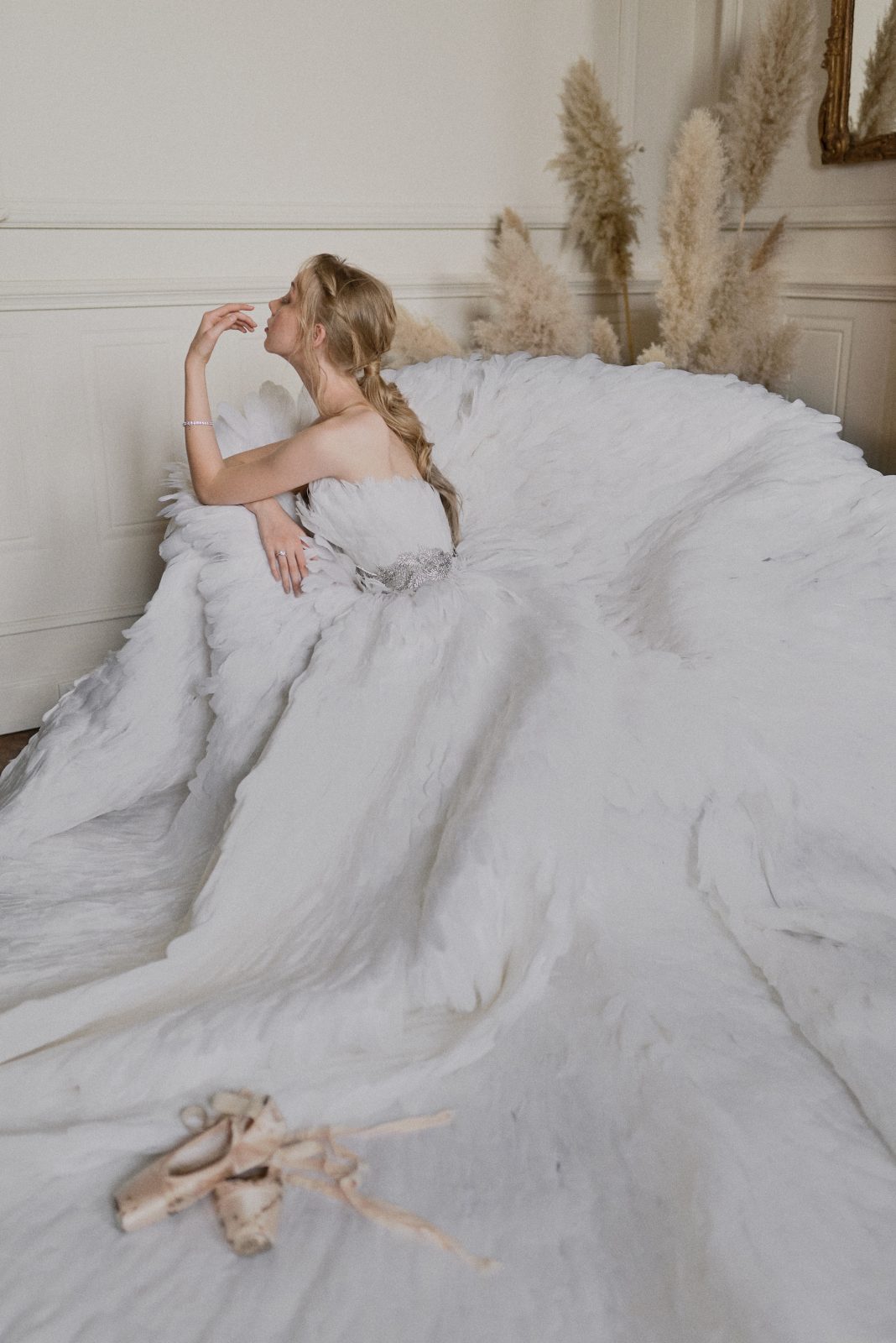 Swan Lake inspired bride with dramatic white feather gown