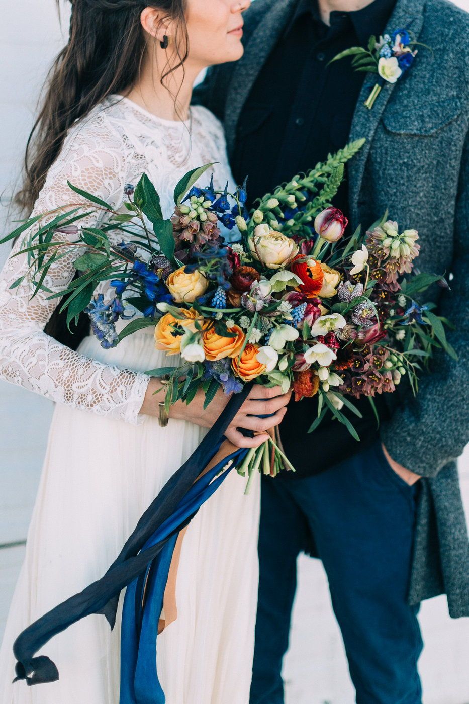 Wild flower wedding bouquet with blue flowers and blue ribbon 