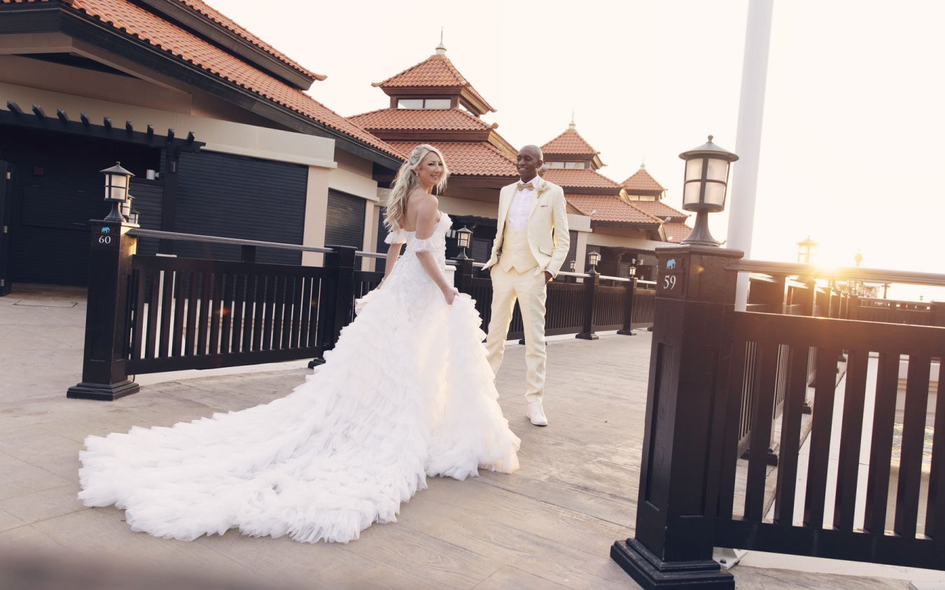 A beautiful couple in wedding attire on a pier