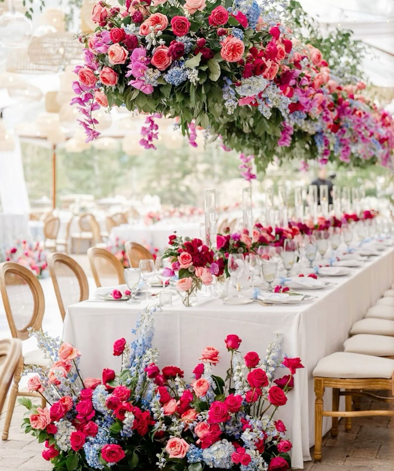 A wedding setup with flowers, table and chairs